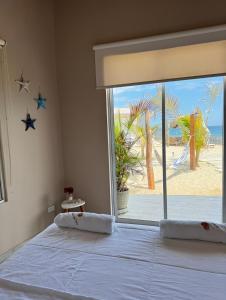 a bedroom with a bed with a view of the beach at Ribera Del Norte in Canoas