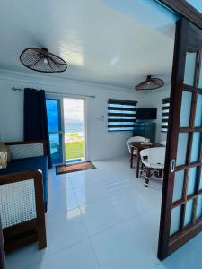 a living room with a view of the ocean at 1888 Beach Resort in Dumaguete