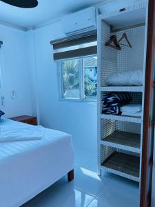 a bedroom with a bed and a room with blue lights at 1888 Beach Resort in Dumaguete