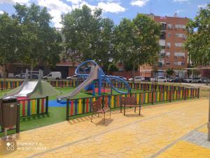 a playground with a slide in a park at Estudio Palacio Congresos Aeropuerto in Seville