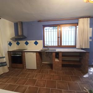 a kitchen with a counter and a window in it at El Cortijo de Marie in Granada