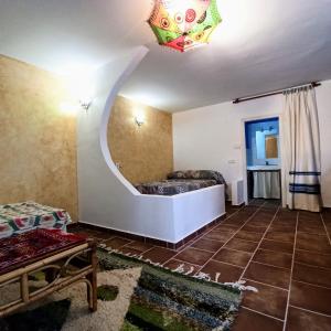 ein Wohnzimmer mit einem Sofa und einem Kronleuchter in der Unterkunft El Cortijo de Marie in Granada