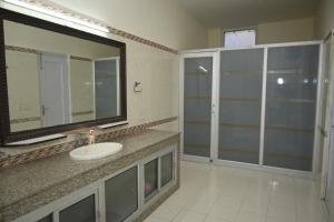 a bathroom with a sink and a large mirror at ownstay chhatarpur in New Delhi