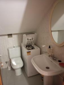 a small bathroom with a toilet and a sink at Dúplex c/Álvaro Cunqueiro 1-3-C1 in Foz