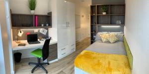 a bedroom with a bed and a desk with a laptop at Conveniently Situated Ensuite Rooms and Studios at Newcastle 1, Near Main Universities in Newcastle upon Tyne