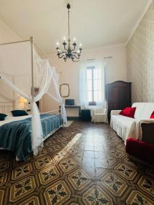 a bedroom with two beds and a chandelier at Il Magnifico Firenze in Florence