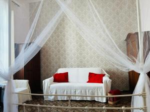 a bedroom with a white bed with red pillows at Il Magnifico Firenze in Florence