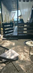 a patio with a table and a chair and a table at Mobile home Ivan Vodice in Vodice