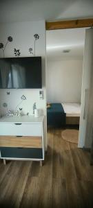 a bedroom with a bed and a white dresser in it at Mobile home Ivan Vodice in Vodice