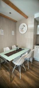 a dining room with a table and white chairs at Mobile home Ivan Vodice in Vodice