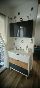 a white dresser with a tv on top of it at Mobile home Ivan Vodice in Vodice