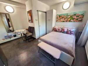 a small bedroom with a bed and a table at By the Mill in Rogoznica