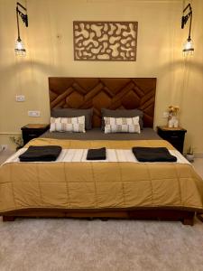 a bedroom with a large bed with a large headboard at Atharva's Homestay by Goaround Homes in New Delhi