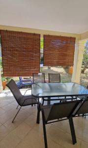 a table and chairs in a room with a patio at Sea-lily Beach Villa in Belle Mare