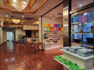 a store with a table and chairs in a room at 大和屋ホテルいろは in Nikko