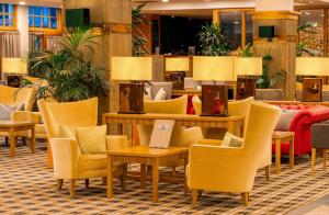 a lobby with chairs and tables in a hotel at Coylumbridge Resort Hotel in Aviemore