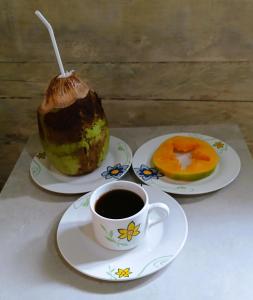 a cup of coffee next to two plates of food at Big Mama's Little House Casa da Mãe Grande in Porto Alegre