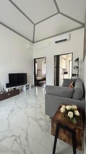 a living room with a couch and a table at Chic & Renovated- Prime Location - 4 min walk to Seaside in Rapallo