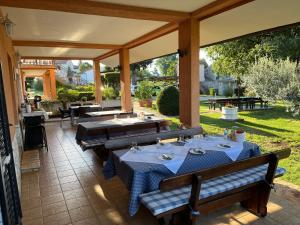 an outdoor dining area with tables and benches on a patio at Rooms Danica in Poreč