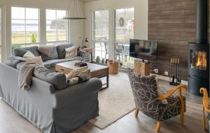 a living room with a couch and a fireplace at Lovely Home In Glanshammar With Kitchen in Glanshammar