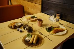 a table with plates of food on it at Готель Добрій in Vorokhta