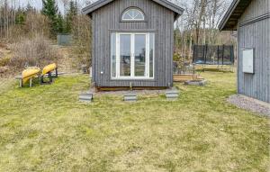 a small house with yellow chairs in a yard at Amazing Home In Glanshammar With Wifi in Glanshammar