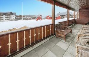 a porch with two chairs and a snow covered yard at Awesome Apartment In Gl With Wifi in Frya