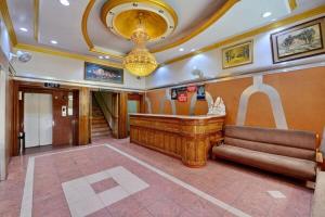 a lobby with a large organ in a building at Hotel President in Gorakhpur