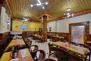 a dining room with tables and chairs in a restaurant at Hotel President in Gorakhpur
