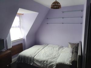 a bedroom with a bed and a window at Goldsmith Rd in London