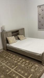 a bed with two pillows on it in a bedroom at La cave aux variétés in Nouakchott
