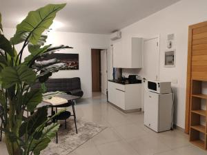 a living room with a couch and a table and a kitchen at Eagle Nest 1-BR in Ashrafieh in Beirut