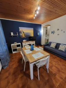 a living room with a table and a couch at Casa LA MARINA in Manarola +20 photos