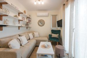 a living room with a couch and a table at Mylarakia in Chios