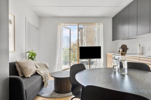 a living room with a couch and a table at Modern luxury apartment in Aarhus