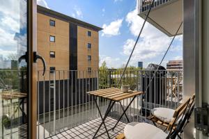 a balcony with a table and chairs and a view at Modern luxury apartment in Aarhus