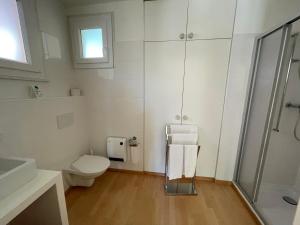 a white bathroom with a toilet and a sink at Residenza Bettina BnB & Ferienwohnungen in Ronco sopra Ascona +95 photos