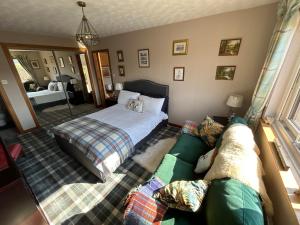 a bedroom with a bed and a couch at The Guest suite at Daviot ,Inverness in Inverness