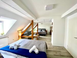 a bedroom with a bed and a living room at City Nowa 1 in Nürnberg