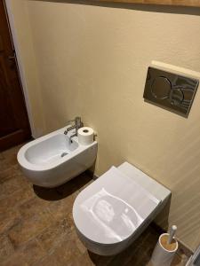 a bathroom with a white toilet and a sink at Borgo di Mezzo in Castelnuovo dellʼAbate