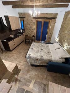 a bedroom with a large bed and a kitchen at Borgo di Mezzo in Castelnuovo dellʼAbate