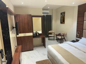 a hotel room with a bed and a desk at Hotel Asha & Banquet in Bettiah