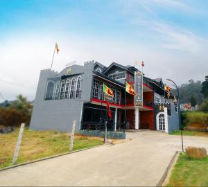 a large building with flags in front of it at Windsor Residence in Nuwara Eliya