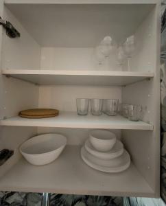 a shelf with plates and bowls and glasses on it at Golf vila3 in San Miguel de Abona