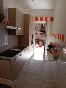 a kitchen with white cabinets and a door to a yard at casArancia 72 in Rome