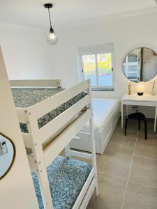 a bedroom with a bunk bed and a mirror at New Flat surround by beaches. in Sagres +12 photos