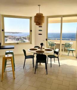 a dining room with a table and chairs and the ocean at Puglia Dreaming seaview apartment in Polignano a Mare