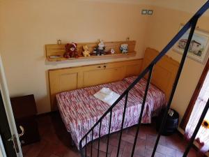 a bedroom with a bed and a shelf with stuffed animals at La Capanna - Stone House in Lucca