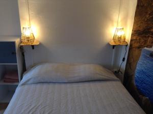 a bedroom with a bed with two lights on it at la loggia in Porto-Vecchio