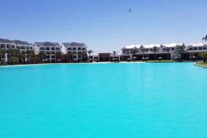 a large pool of blue water in front of buildings at The Blyde in Pretoria